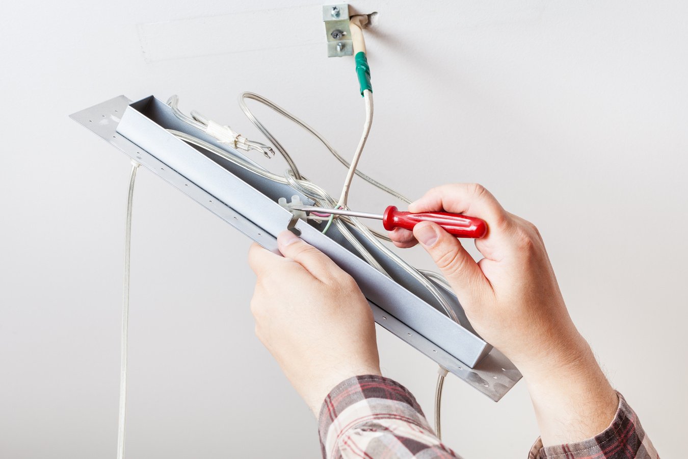 Electrician Installs Wiring for Lamp